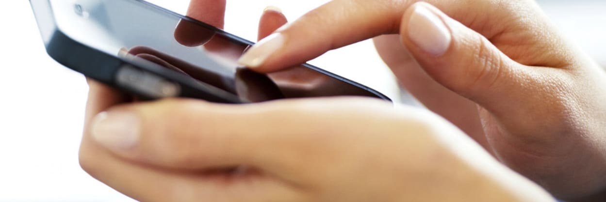 Person using a smartphone with a finger on the screen.